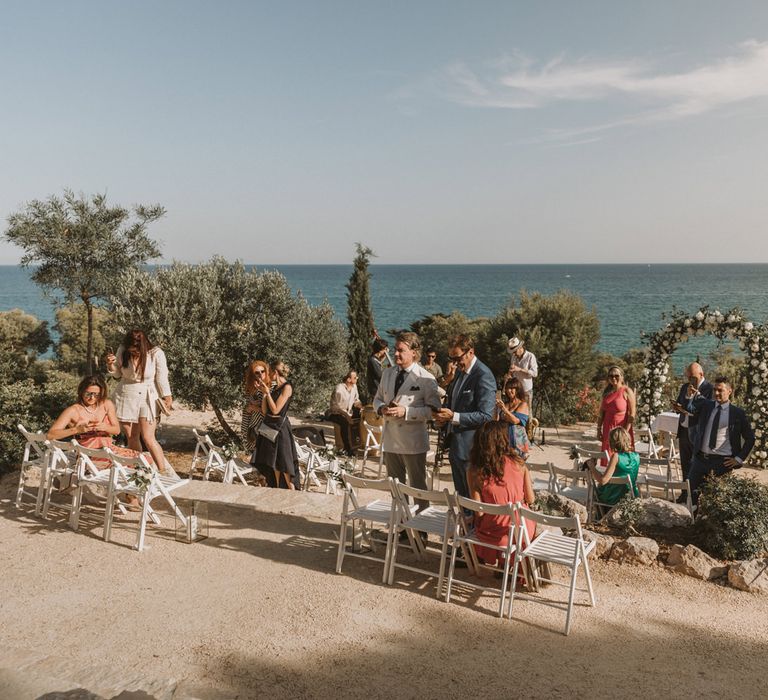 Wedding guests at outdoor Spanish wedding ceremony 