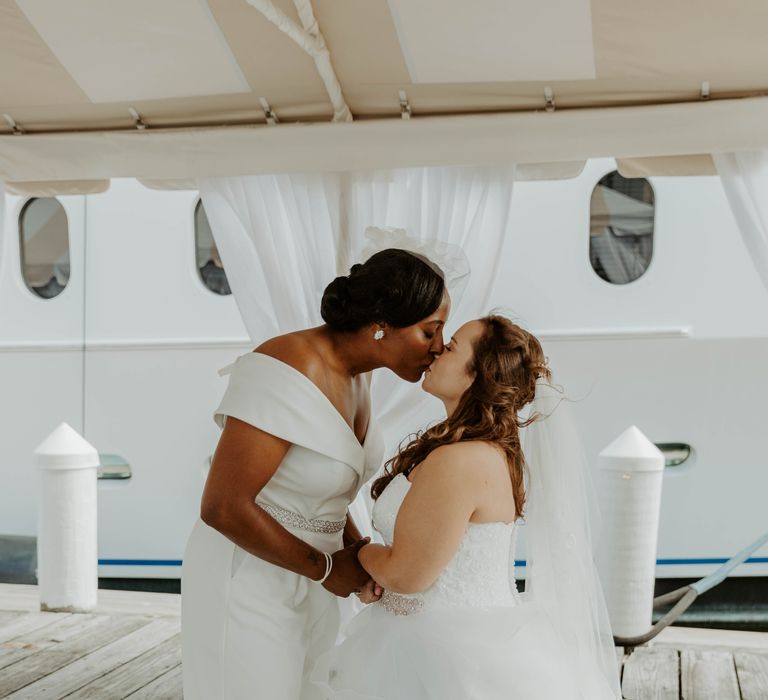 Two brides kissing at their first look