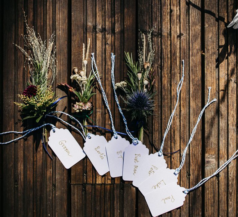 wildflower buttonholes with luggage tag names 