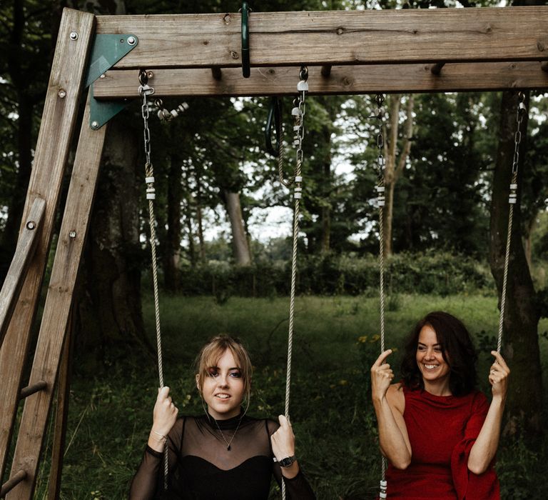 Bride swings with wedding guest on wedding day