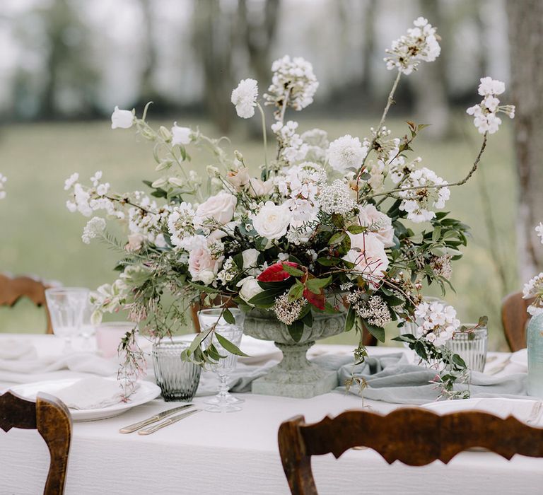 Rustic and luxurious white floral centrepiece for outdoor woodland wedding at Chateau de la Ruche