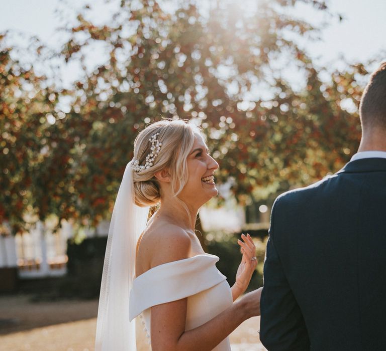 Bride laughs in the sunshine 