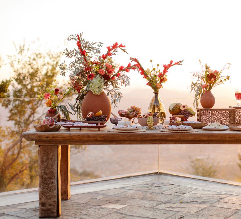 Greek food grazing table overlooking a view of Portaria as the sun begins to set