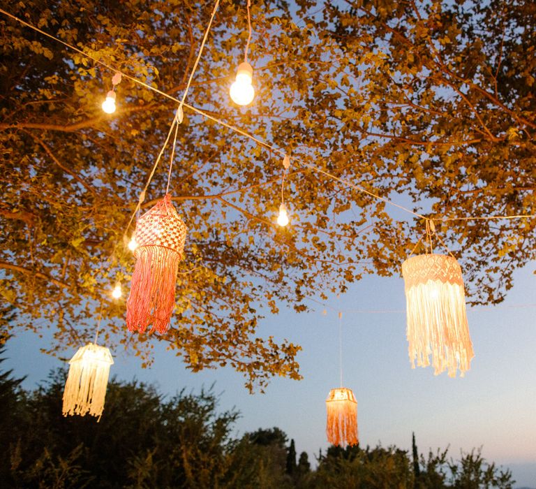 Hanging lanterns from trees to illuminate the dance floor as the sun goes down