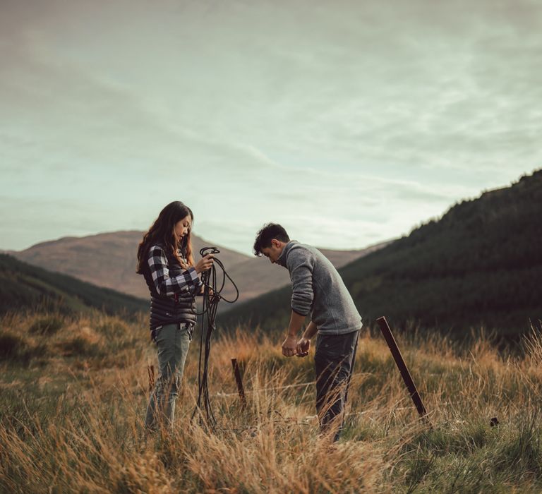 Couple get ready to go rock climbing on the mountains 