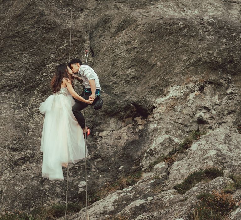 Couple during engagement session rocking climbing in Scotland