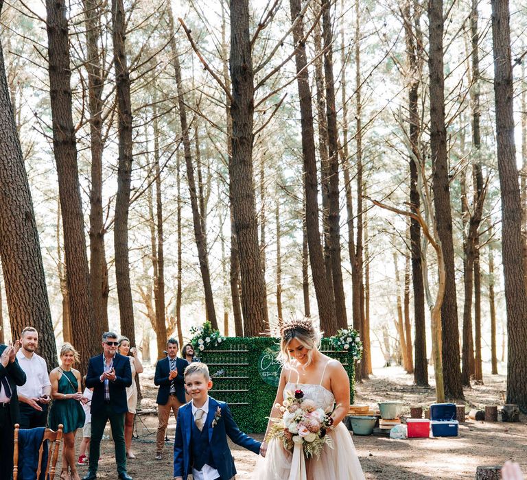 Bride walks down the aisle at forest wedding in tulle skirt wedding dress