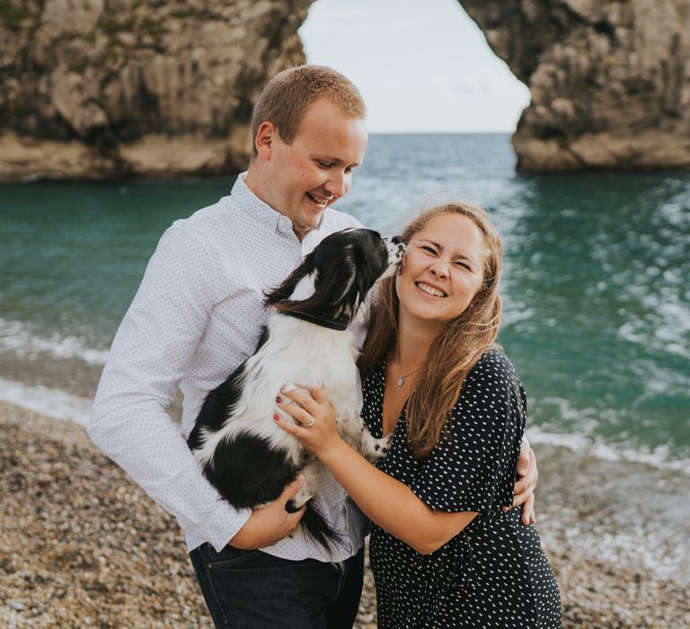 Beach engagement photography with dog and view of the sea 