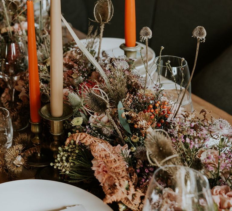 Autumn wedding decor with dried flower table runner and taper candles 