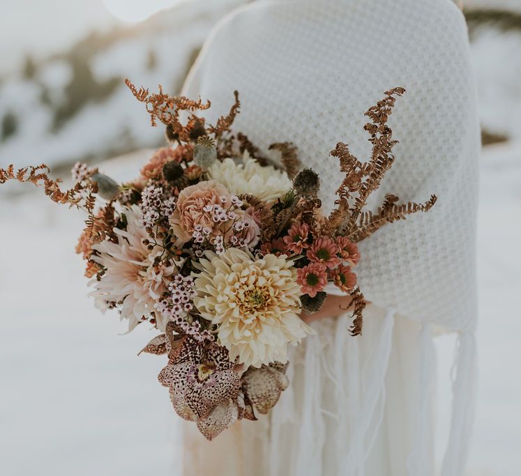 Orange autumn wedding bouquet with orchids, dahlias, roses and carnations