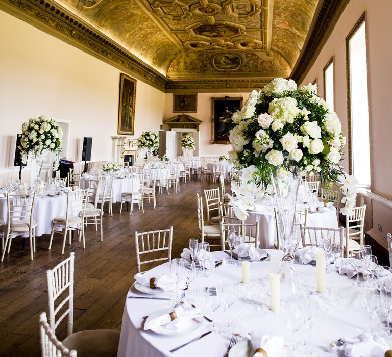 Classic wedding reception complete with large white floral displays set in gilded room