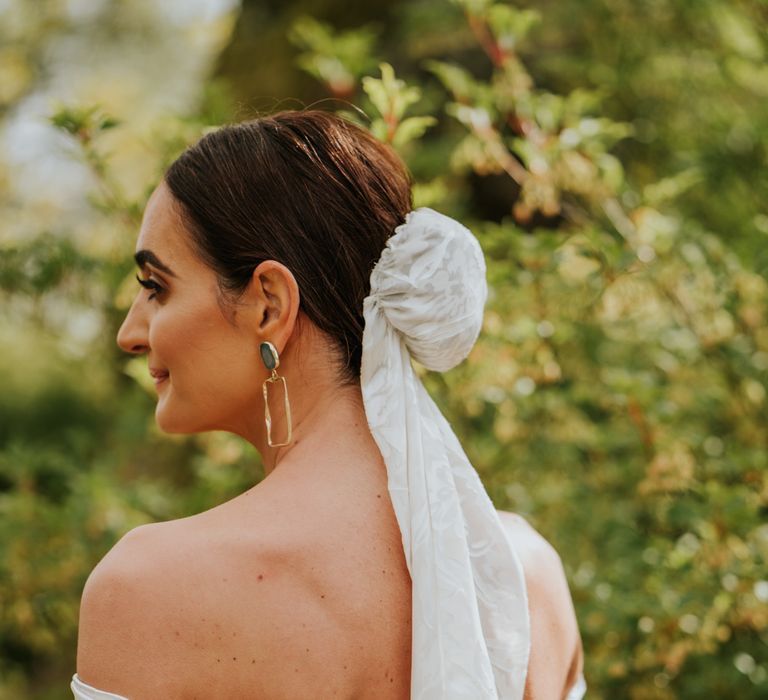 Bridal bun with veil and off the shoulder wedding dress