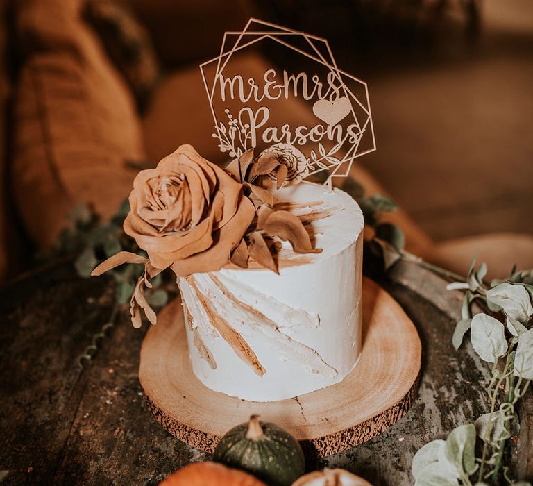 Single tier wedding cake for autumn wedding with personalised wooden cake topper and flower decor 