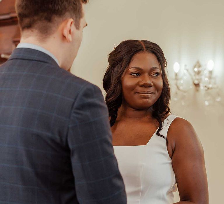 Bride looks towards celebrant on her wedding day during wedding ceremony