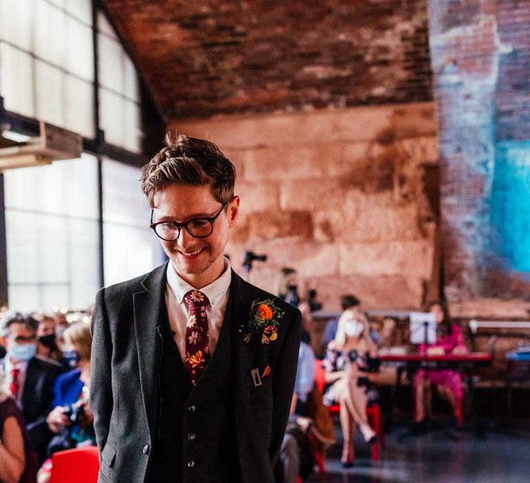 Groom wears three piece suit as he awaits bride on his wedding day