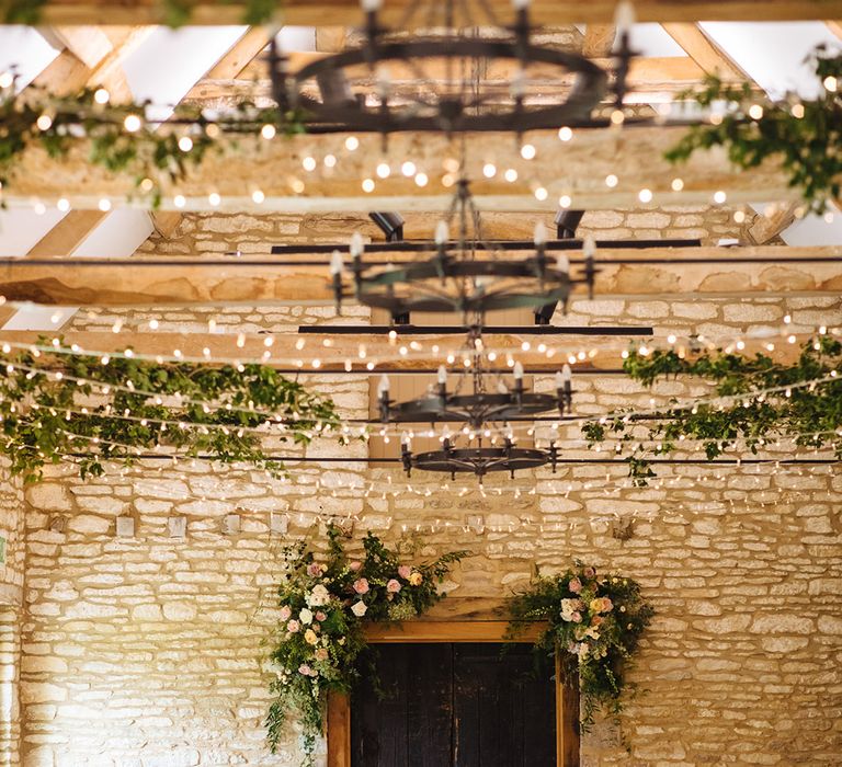 Caswell House wedding venue decorated with fairy lights and greenery 