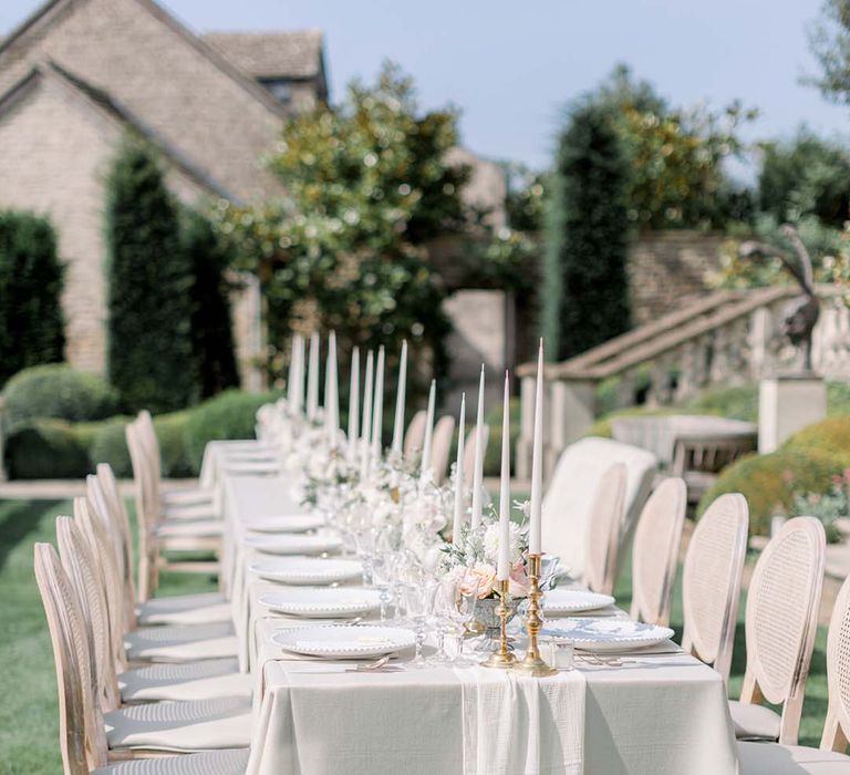 Simple white tablescape for grand table outdoors 