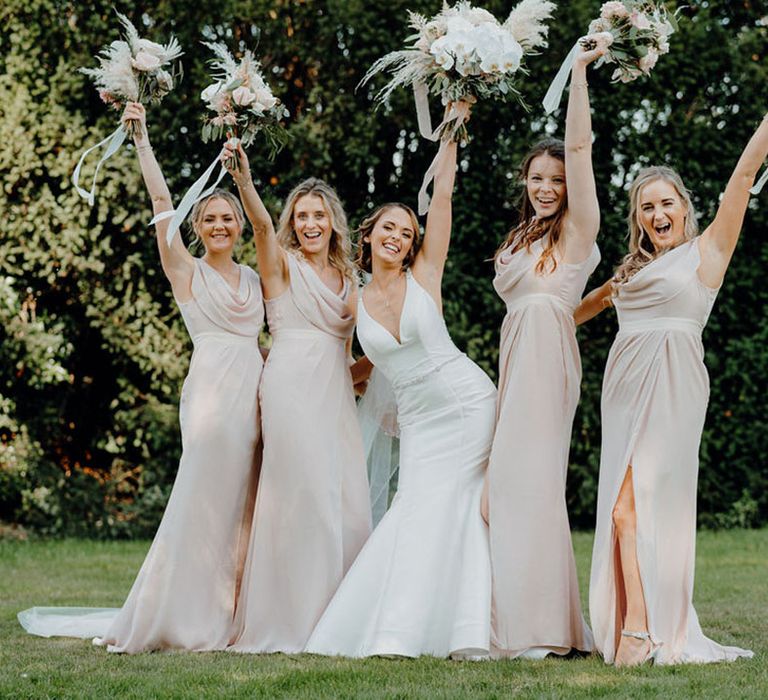 Bride in fishtail wedding dress by Morilee and bridal party in ASOS pink bridesmaid dresses at Elmore Court