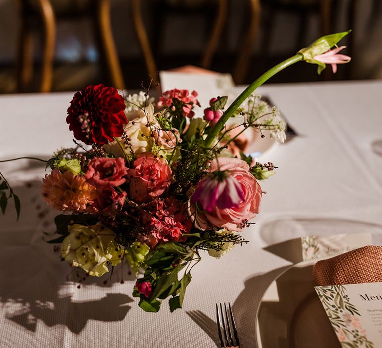 Pink and red wedding flowers for tables with roses and dahlias