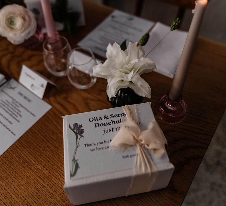 long coloured taper candles and wedding favour boxes on the wedding reception tables 