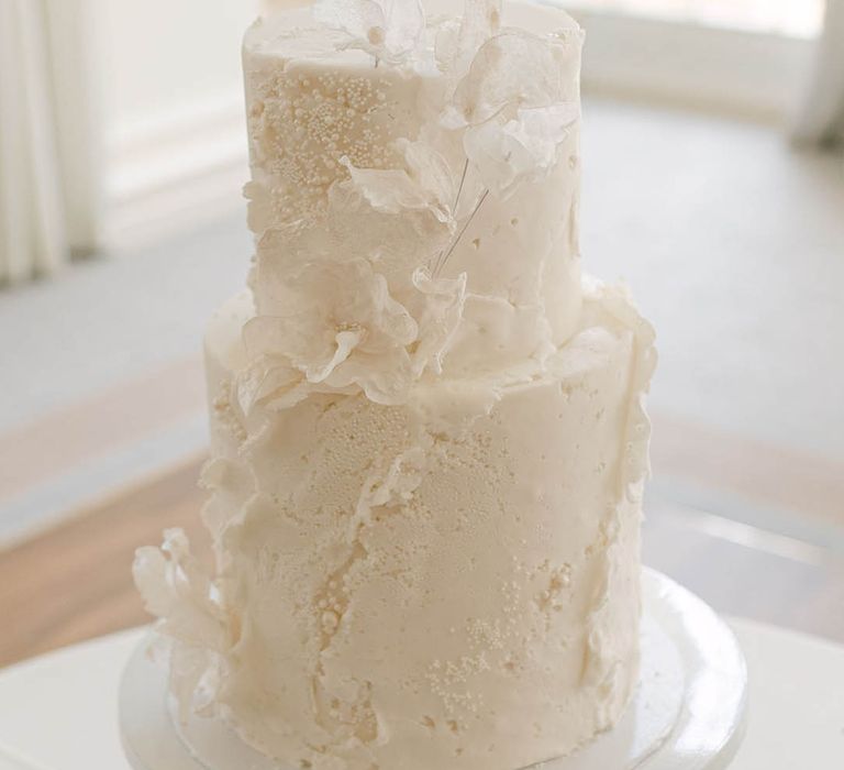 Modern and classic two tier white iced wedding cake with attention to texture 