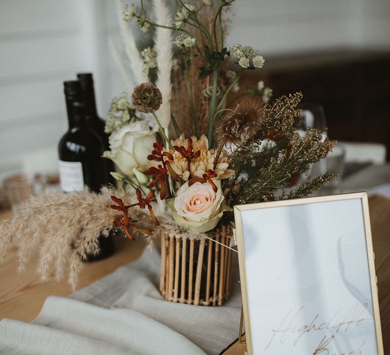 Dried florals on wooden table complete with fabric table runner 