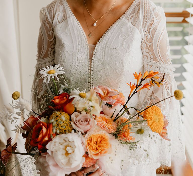 Bride in a v-neck long sleeve lace wedding dress 