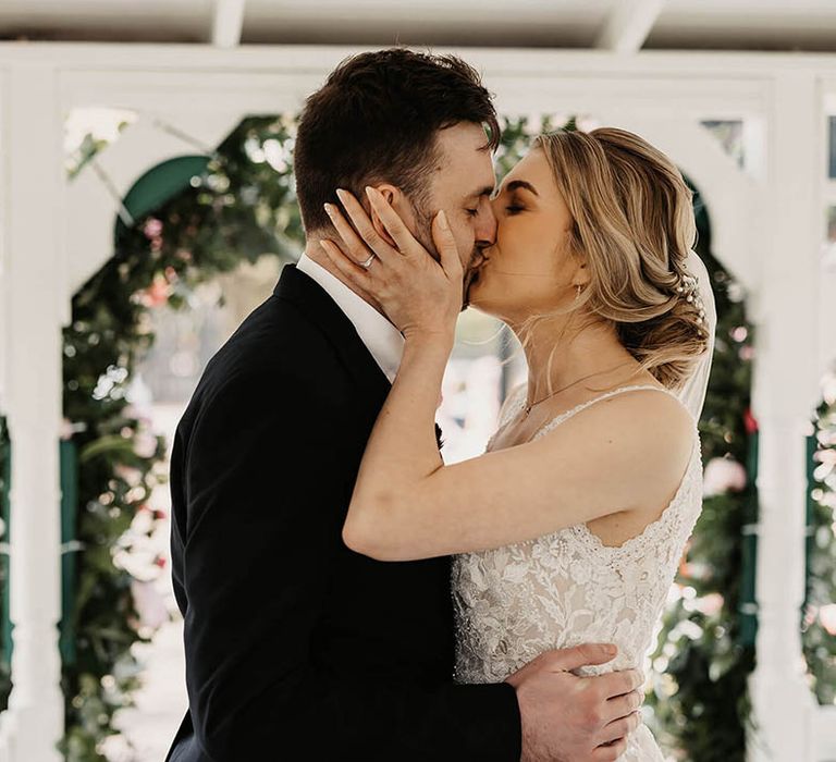 Bride and groom share their first kiss as a married couple 