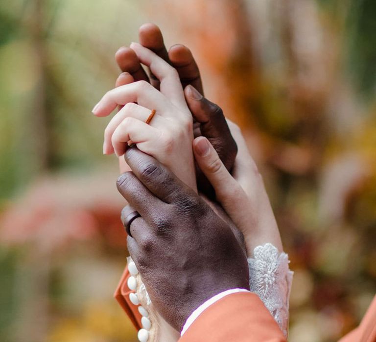 Bride and groom showing off their sustainable, eco-friendly wooden wedding rings