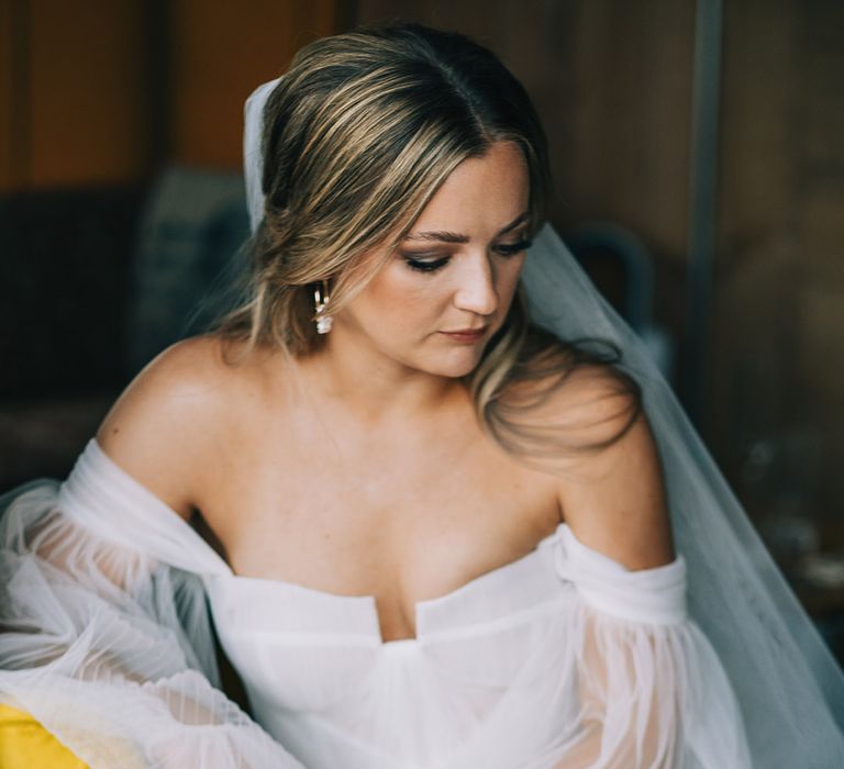 Bride in pleated tulle wedding dress with off the shoulder detail for festival wedding in Cambridge 