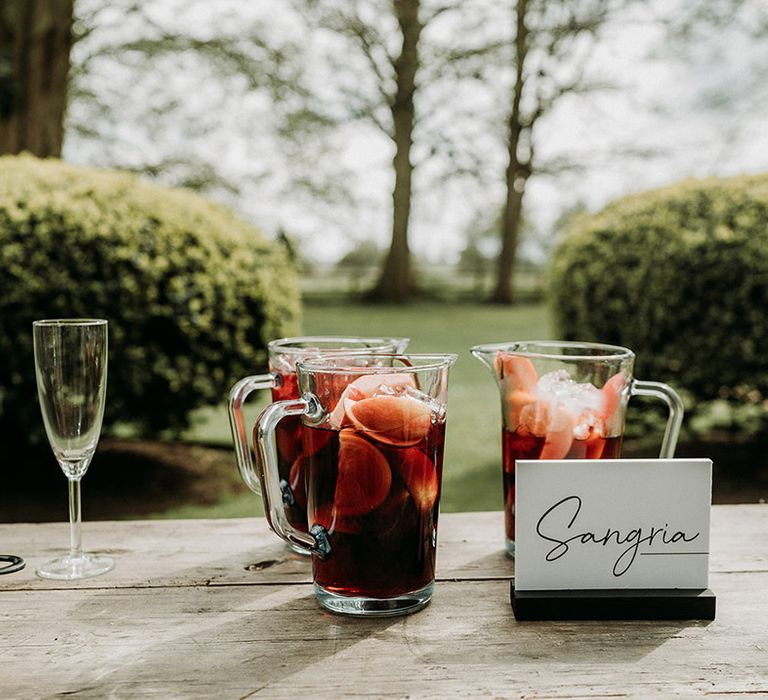 Sangria wedding drink in large jug with black and white table sign for outdoor wedding drinks 