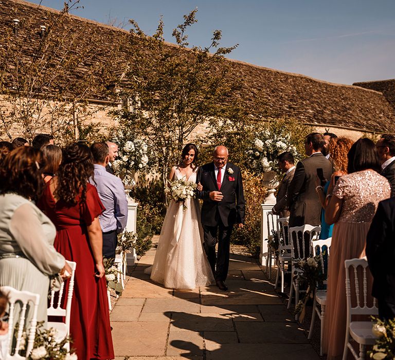 wedding ceremony bridal entrance at Caswell House with bride walking down the aisle in a Gabbiano princess wedding dress