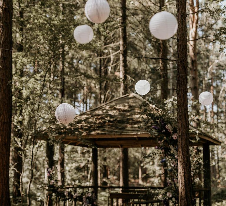 Camp Katur wedding in a woodland with white paper lanterns and gazebo