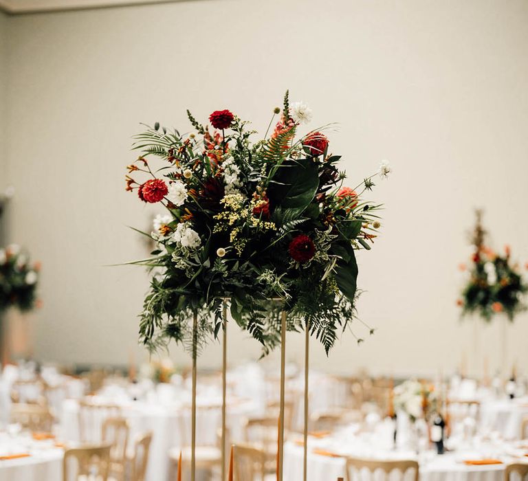 Tall floral wedding table centrepiece with orange flowers for contemporary twist at classic country house wedding 