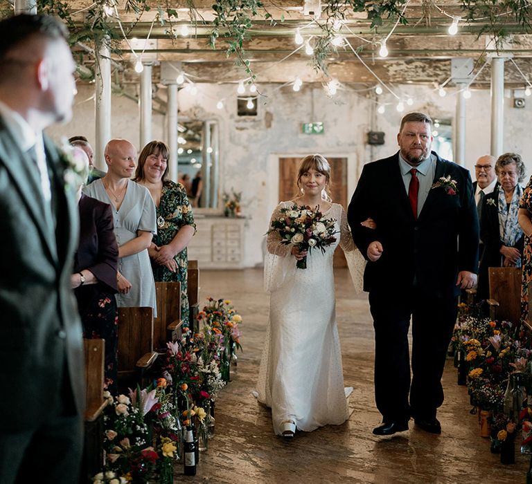 Pregnant bride is walked down the aisle at the Holmes Mill industrial style wedding venue 