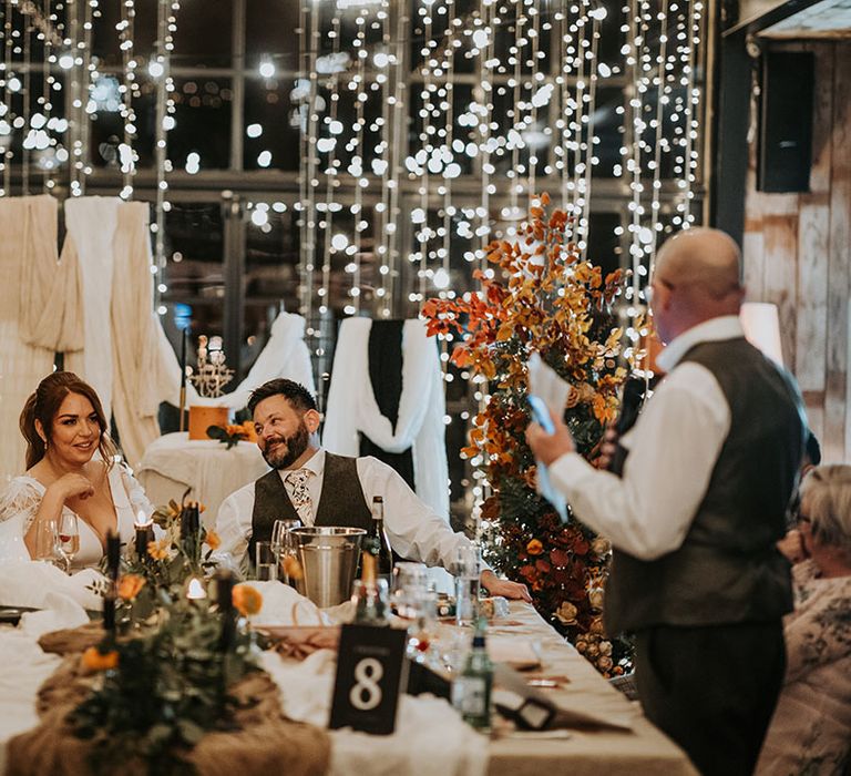 Wedding fairy light decorations at Hidden River Barn as the wedding guests give speeches 