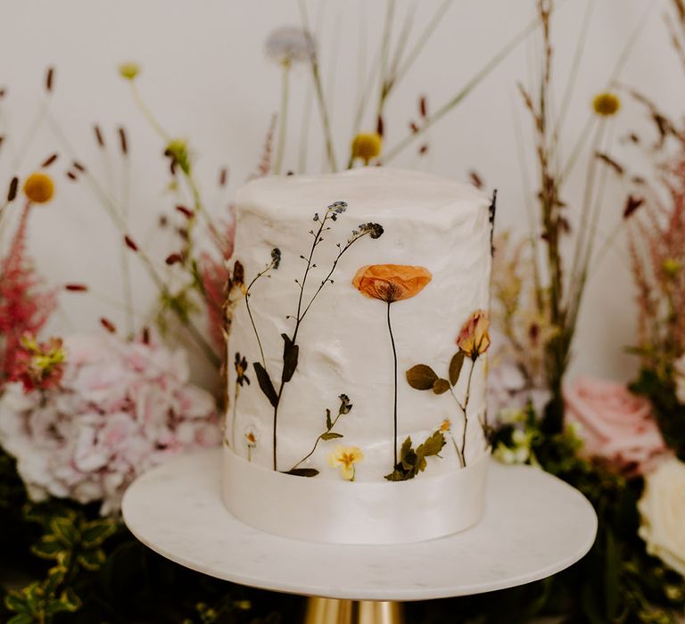 Wildflower pressed wedding cake with white icing 