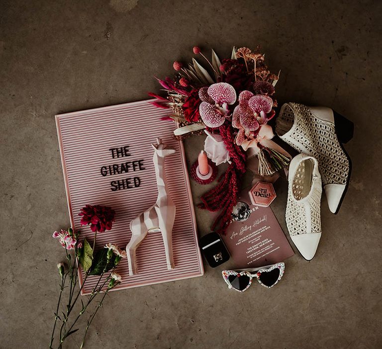 Pink wedding stationery, bridal accessories and white boots for the bride 