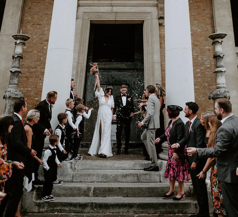 Traditional confetti exit from the wedding ceremony venue 