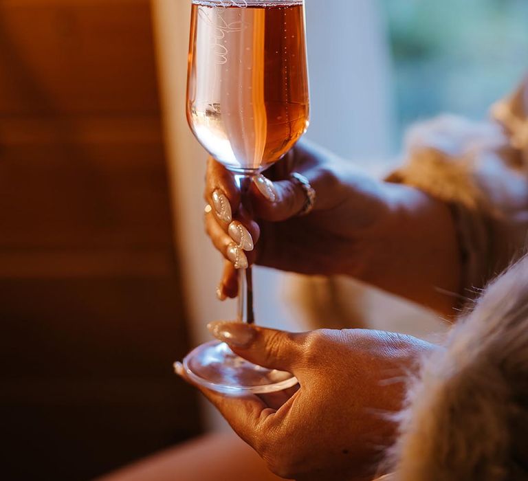 Personalised wifey wine glass held by bride on the morning of the wedding 