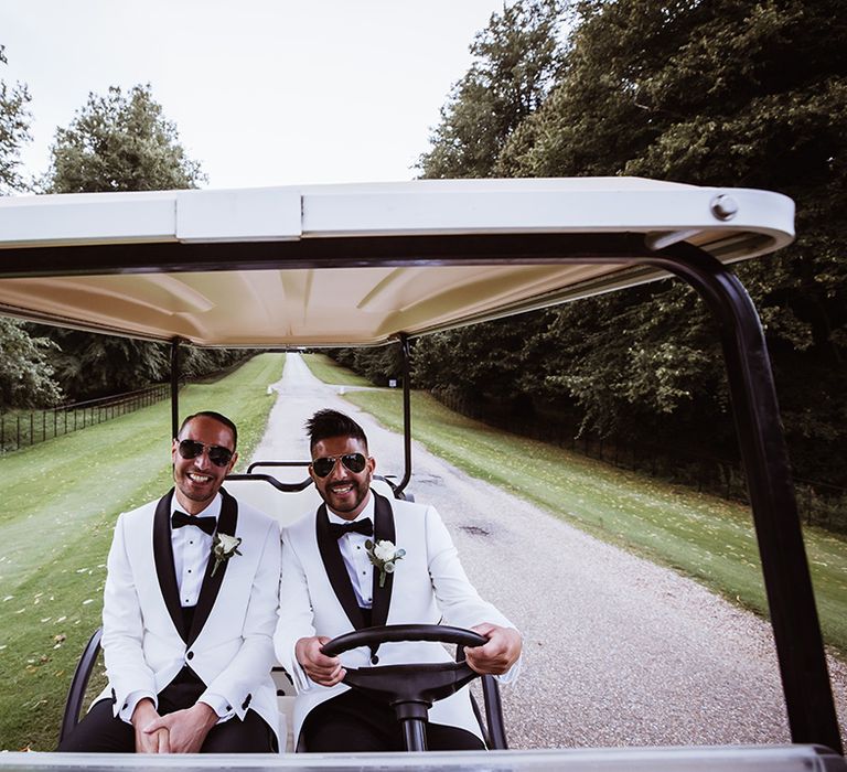 The two grooms ride their golf buggy at gay wedding in Essex