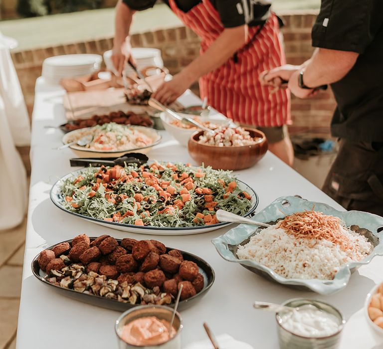 Wedding breakfast with bowls of food for guests to help themselves to 