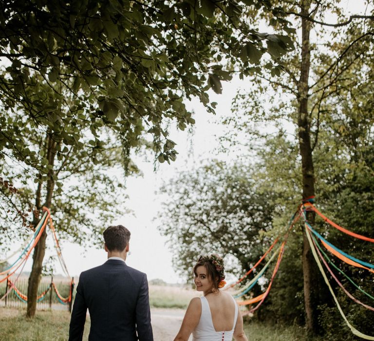 bride and groom walking down at country land at Thurstons Farm wedding