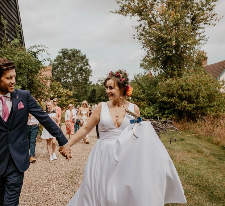 Bride and groom walking hand in hand 