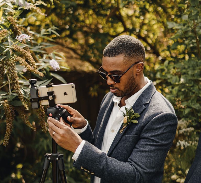 Best man setting up a live stream of the wedding 