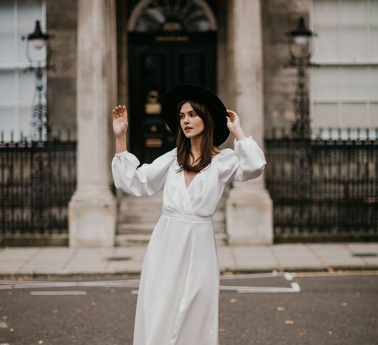 Bride in wrap dress with fedora hat and silver boots 