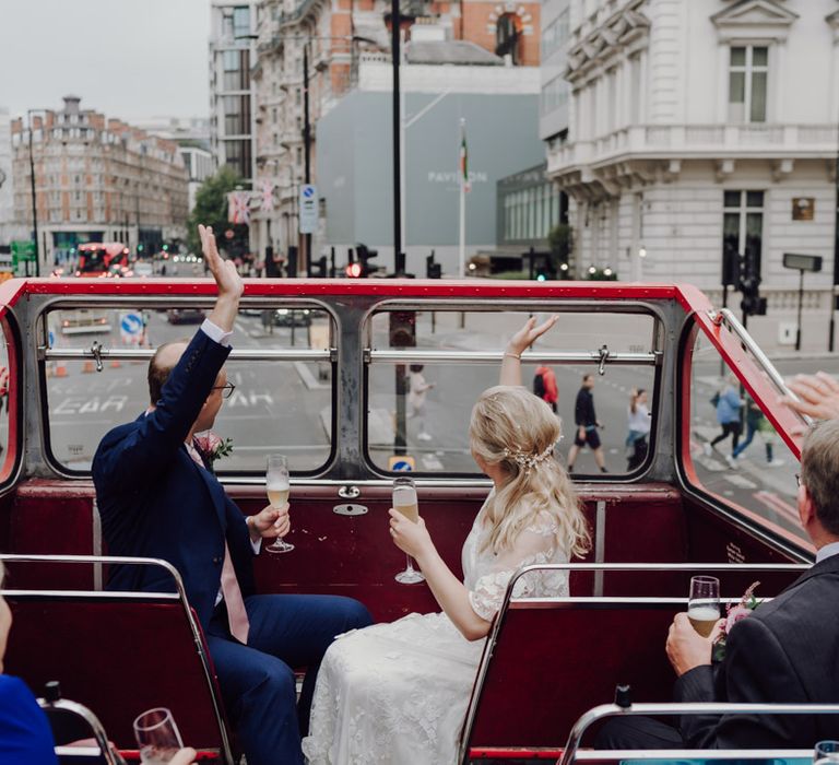 Bride and groom enjoy ride on London wedding bus