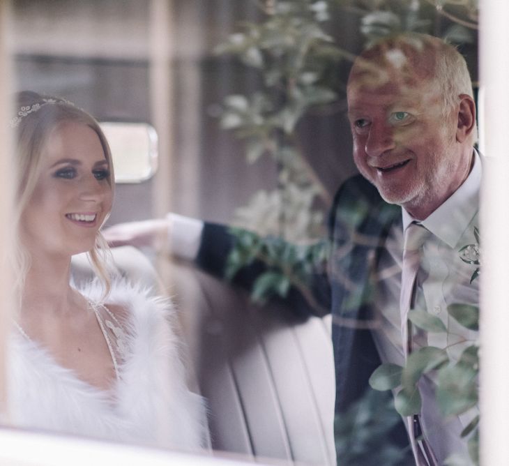 Bride and father of the bride in vintage wedding car