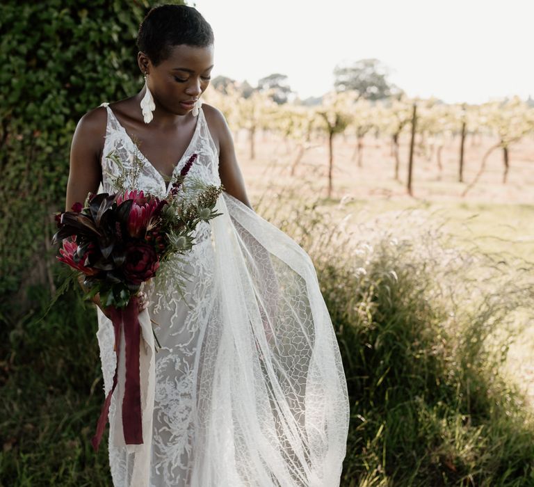 Black bride in an embellished lace wedding dress with watteau train 