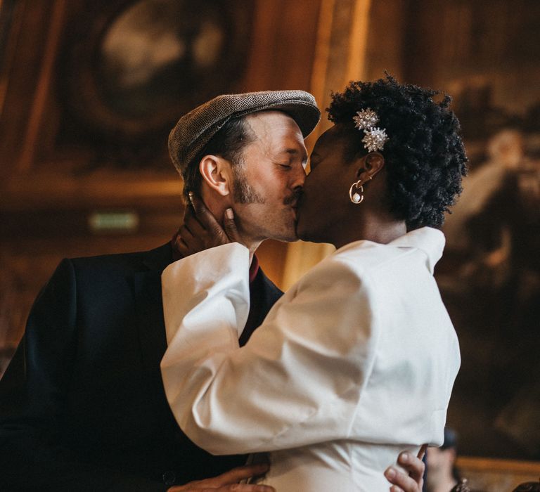 Bride and groom kissing at their French town hall wedding 